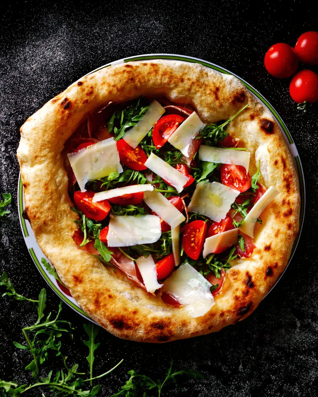 Product photography — prosciutto pizza on dark background